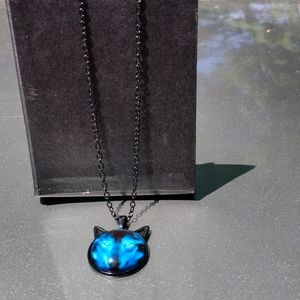 Wolf necklace on black background and black chain.